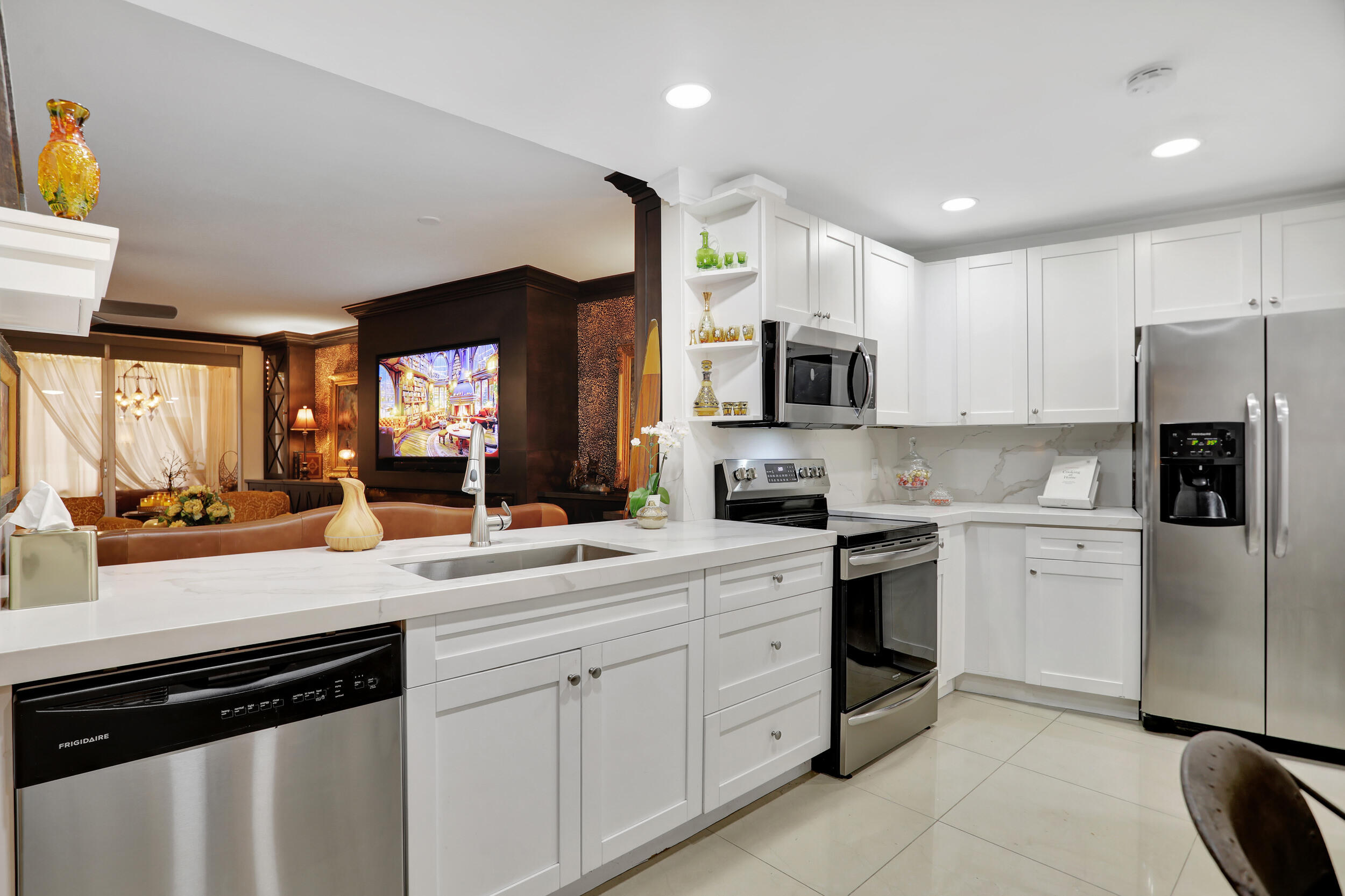 a kitchen with a sink cabinets and stainless steel appliances