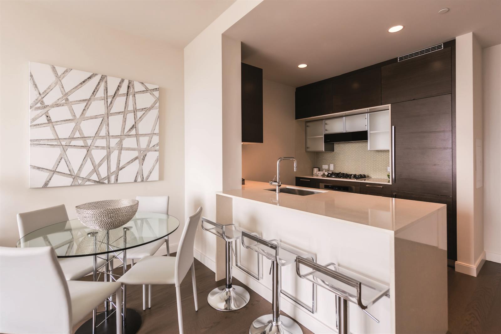 a large white kitchen with a large window