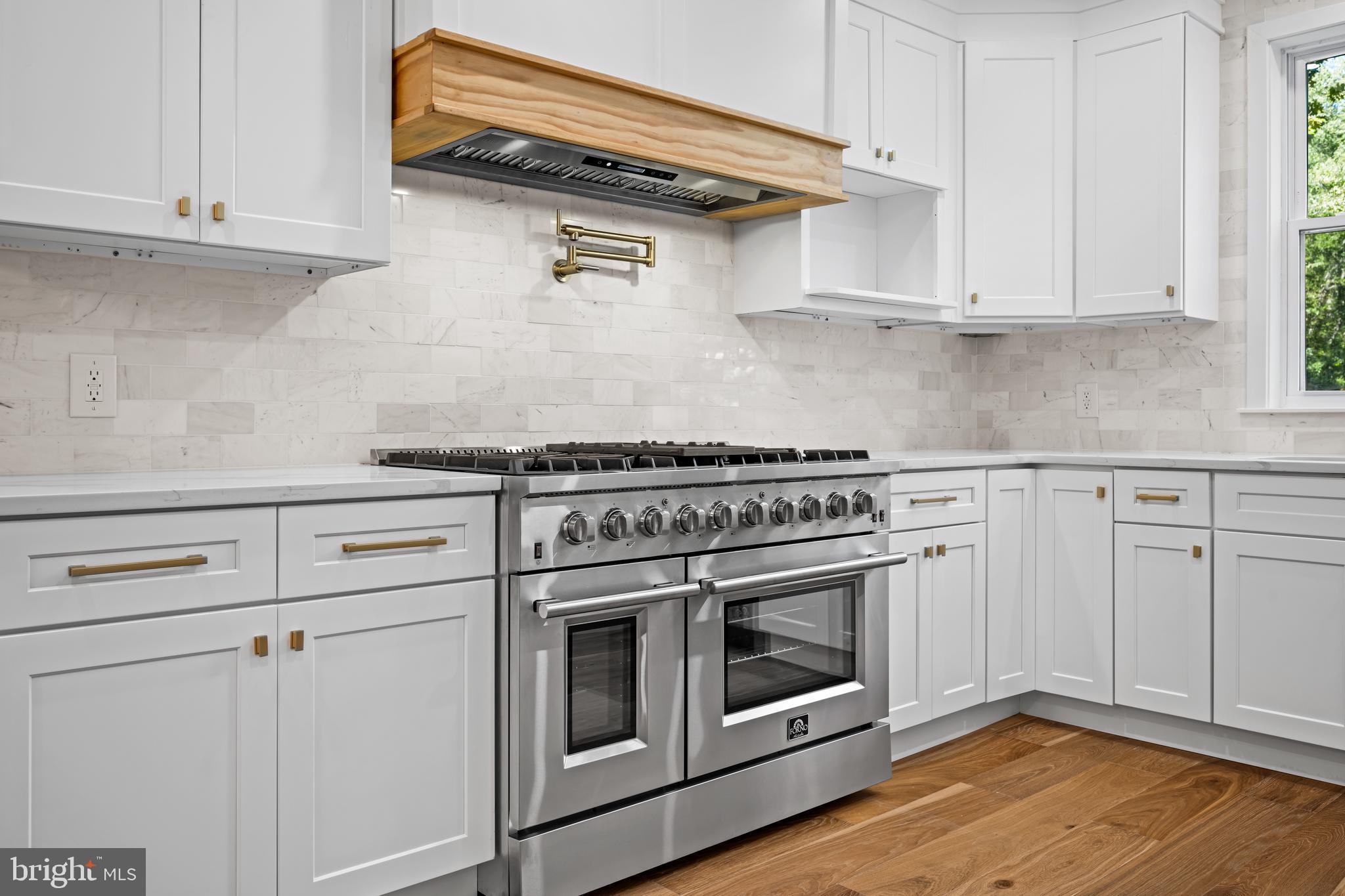 a stove top oven sitting inside of a kitchen