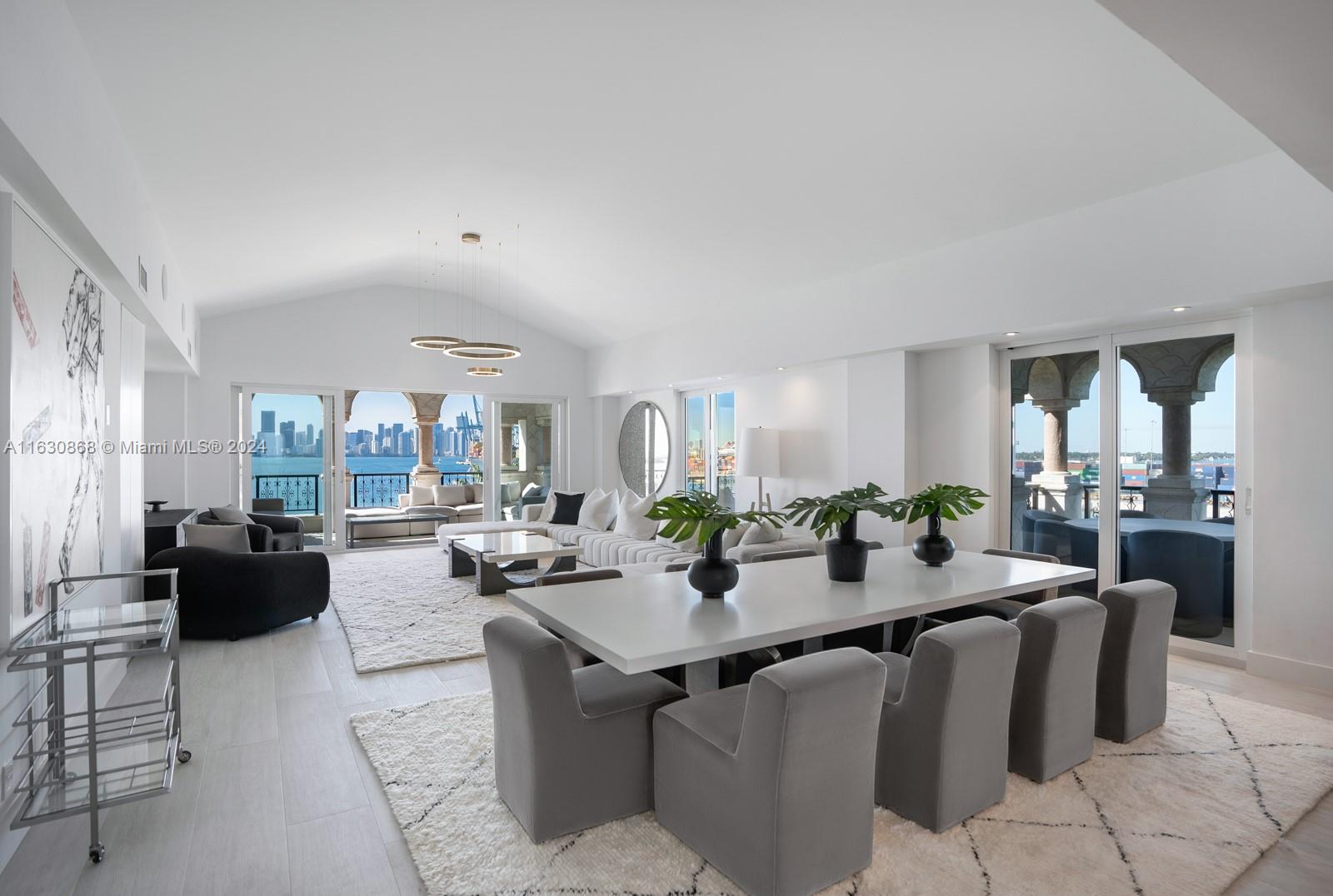 a view of a dining room with furniture a kitchen and chandelier