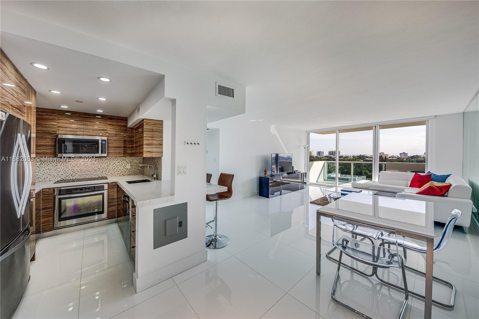 a kitchen with stainless steel appliances kitchen island granite countertop a sink and counter space