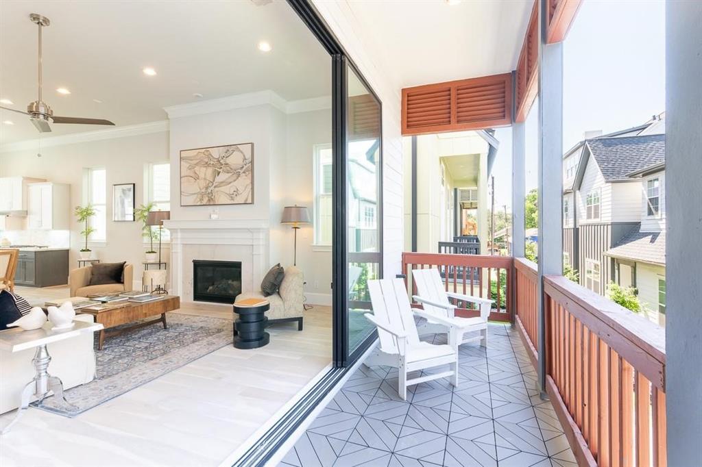 a living room with furniture a fireplace and a large window