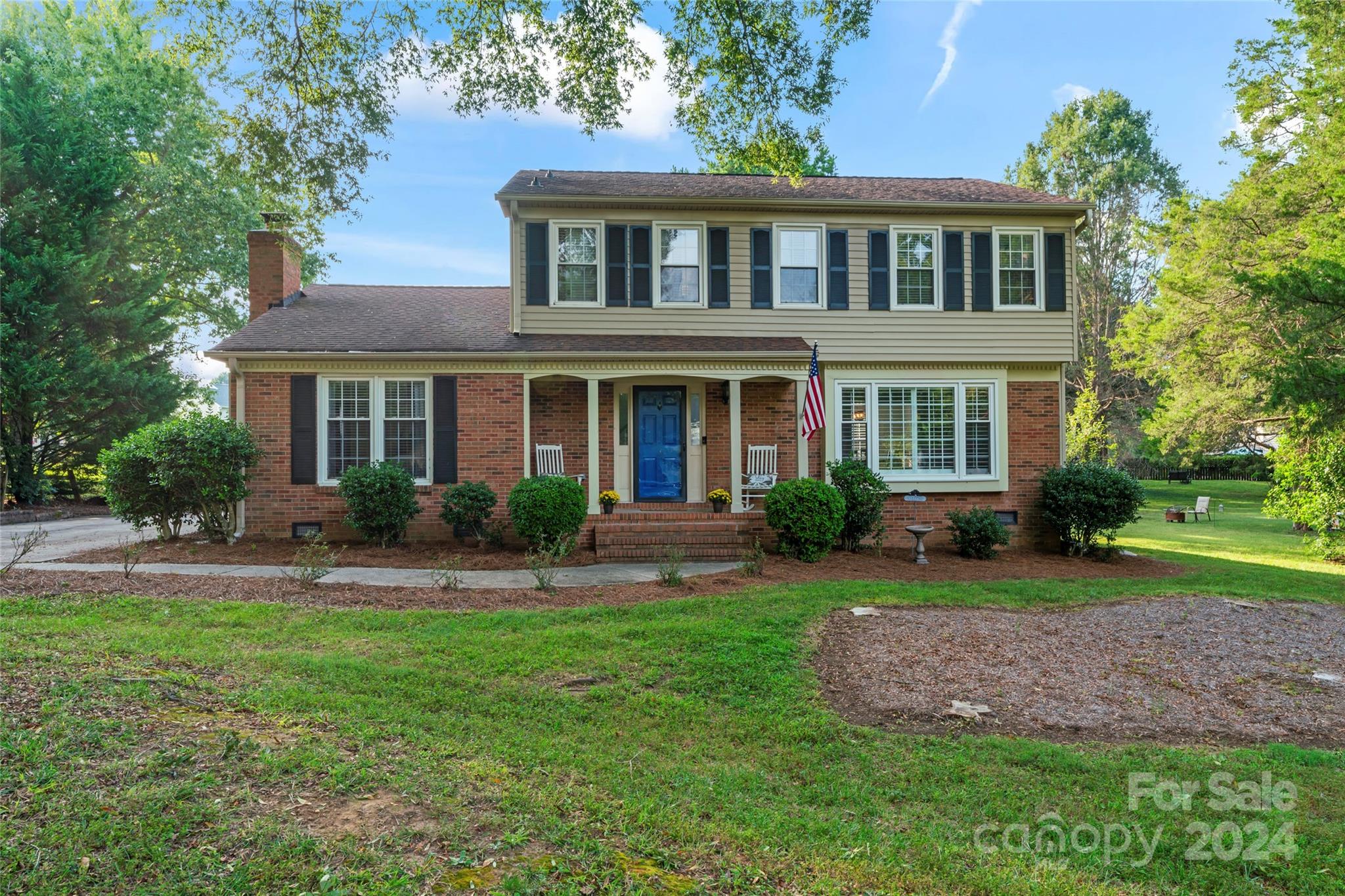 a front view of a house with a yard and porch