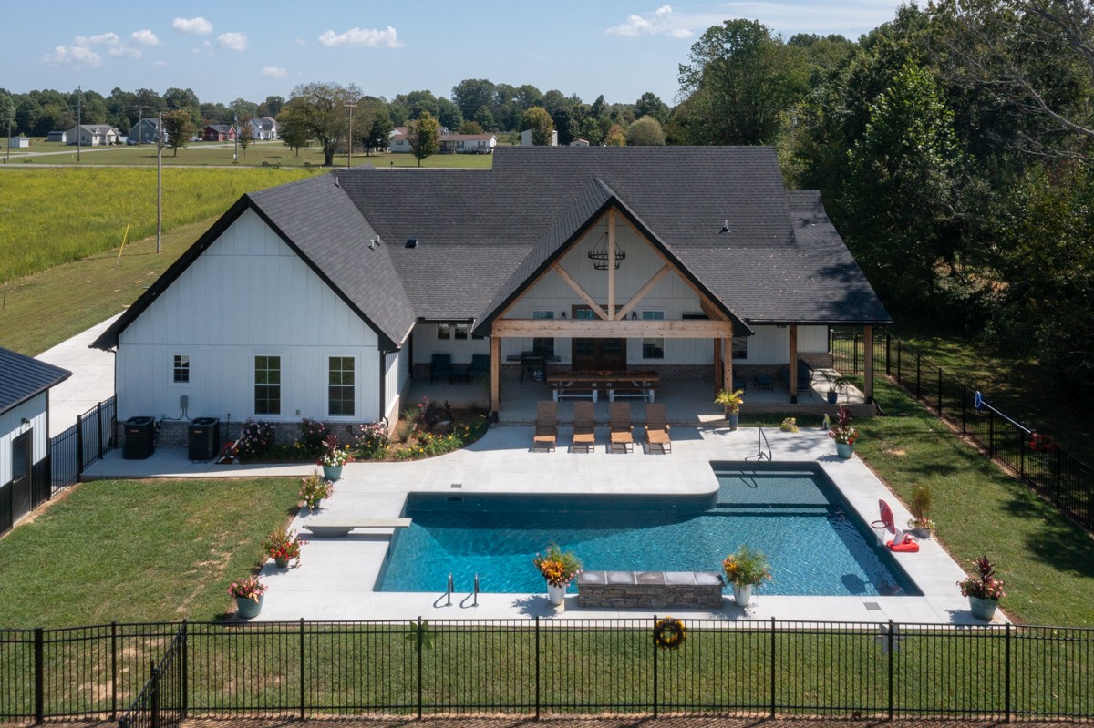 a aerial view of a house with swimming pool and patio