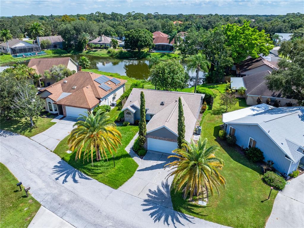 an aerial view of a house with garden space and lake view