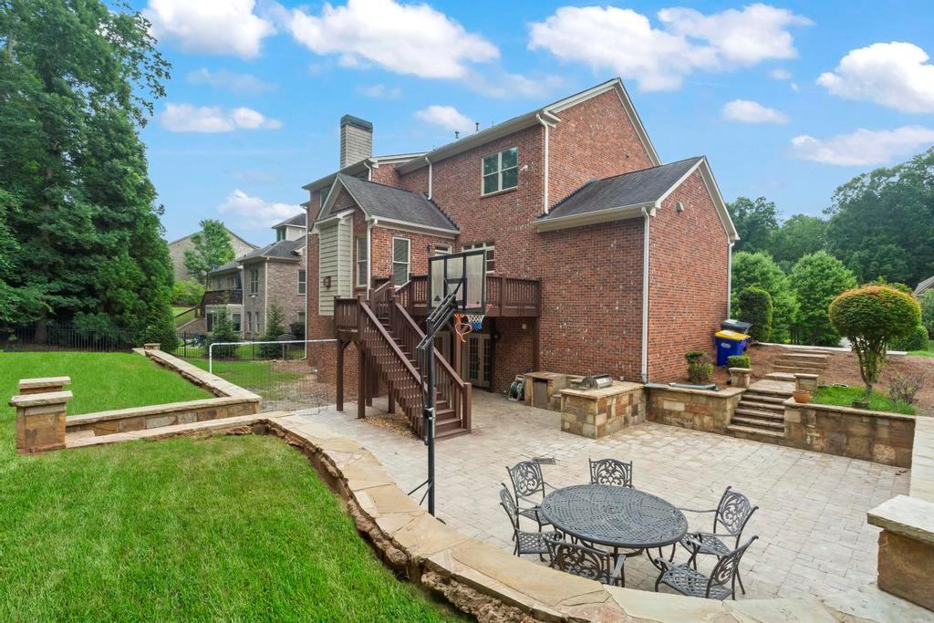 a view of a house with backyard and sitting area