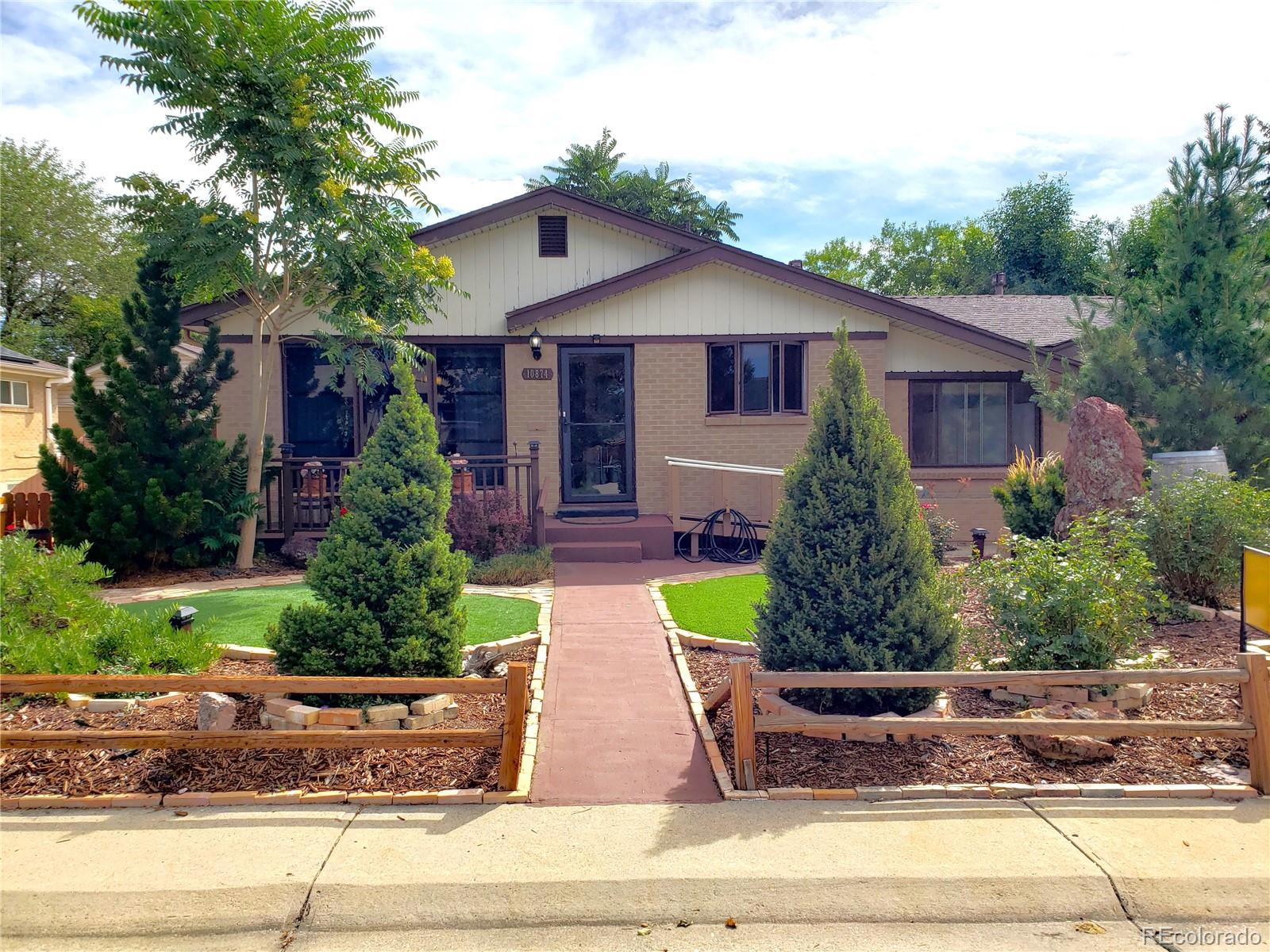 a front view of house with yard and green space