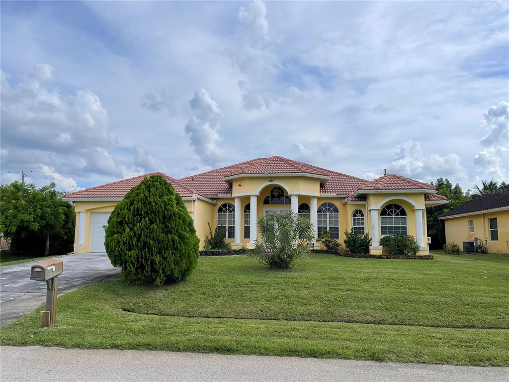 a front view of a house with a garden