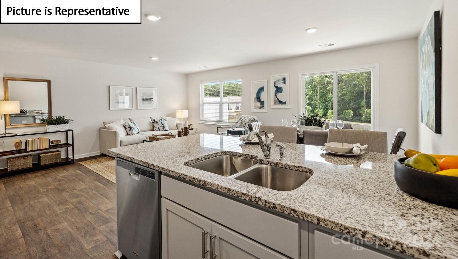 a kitchen with granite countertop a sink and a counter top space