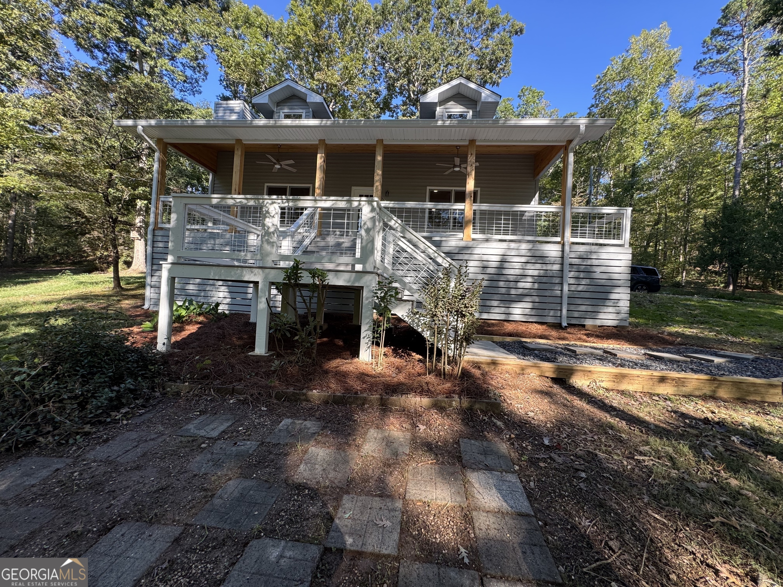 a front view of house with yard outdoor seating and barbeque oven