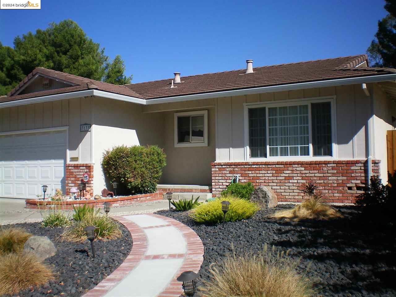 a front view of a house with garden