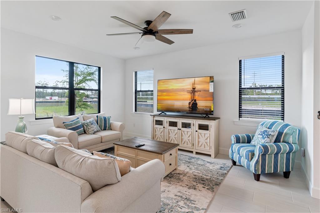 a living room with furniture and a flat screen tv