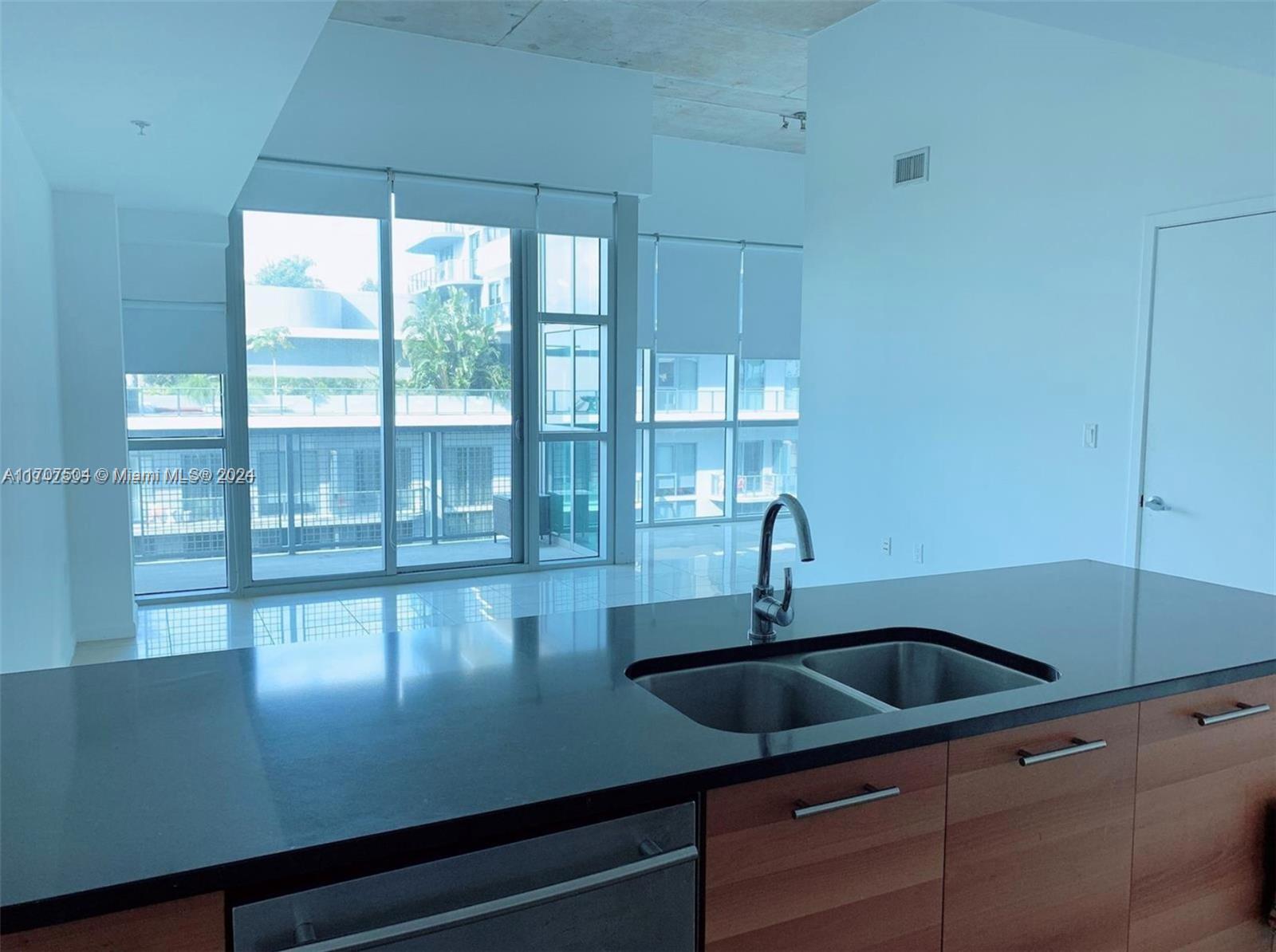 a kitchen with a sink and large window