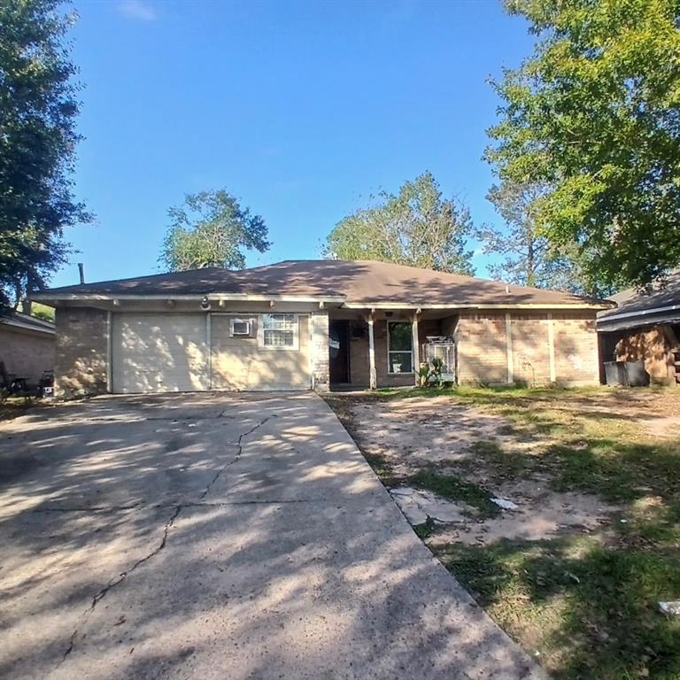 a front view of a house with a garden and tree