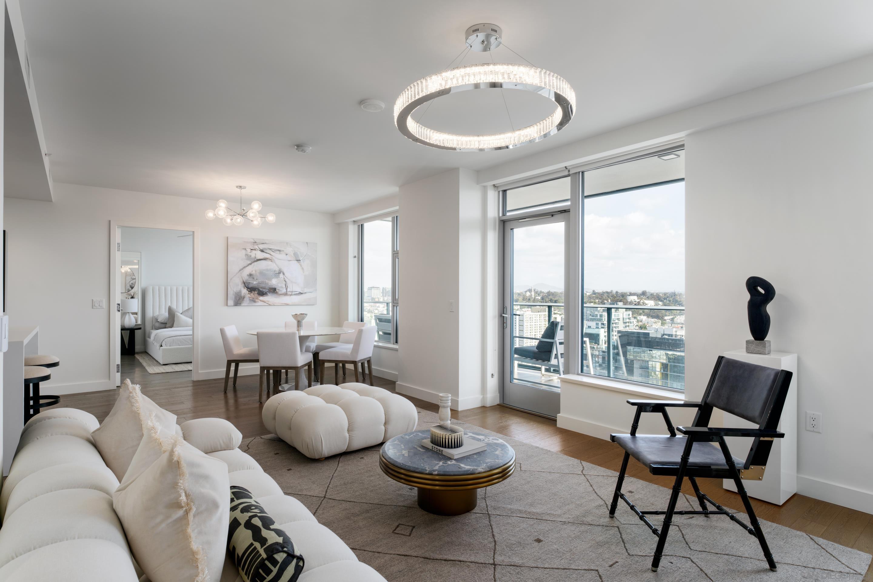 a living room with furniture and a floor to ceiling window