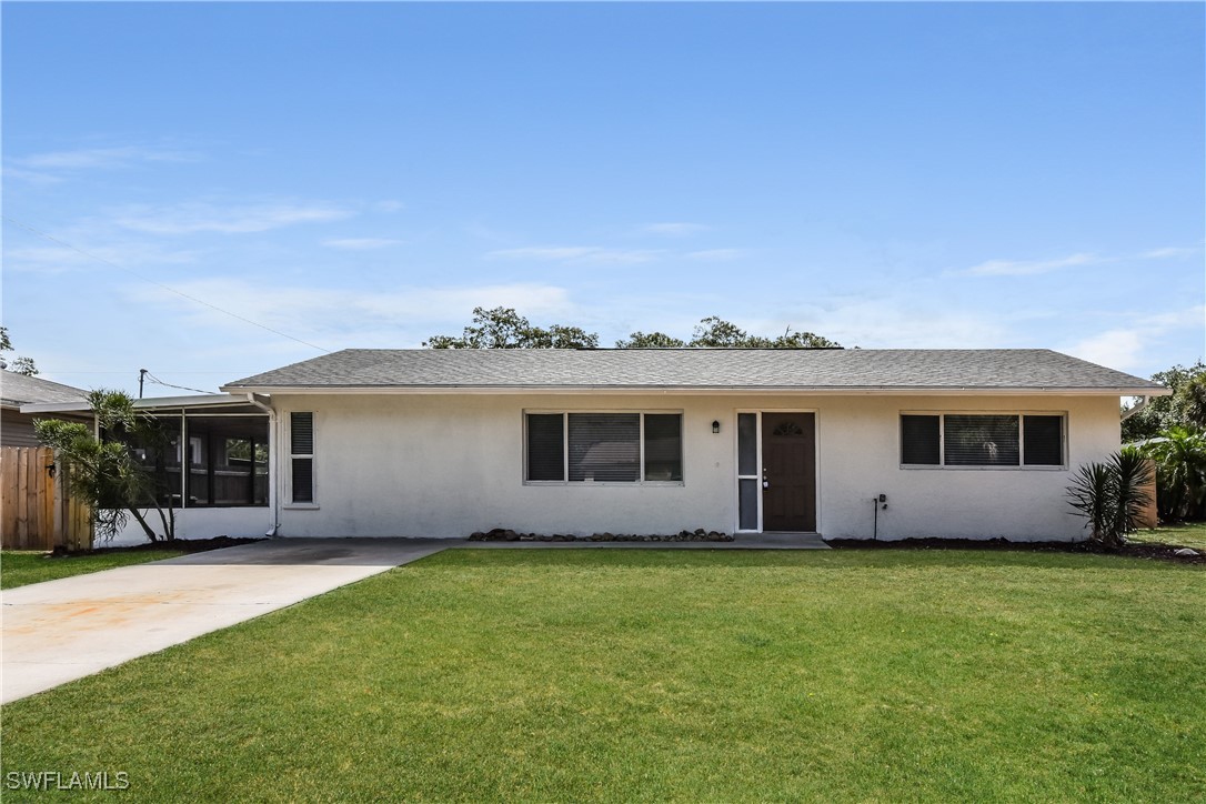 a front view of house with yard and green space