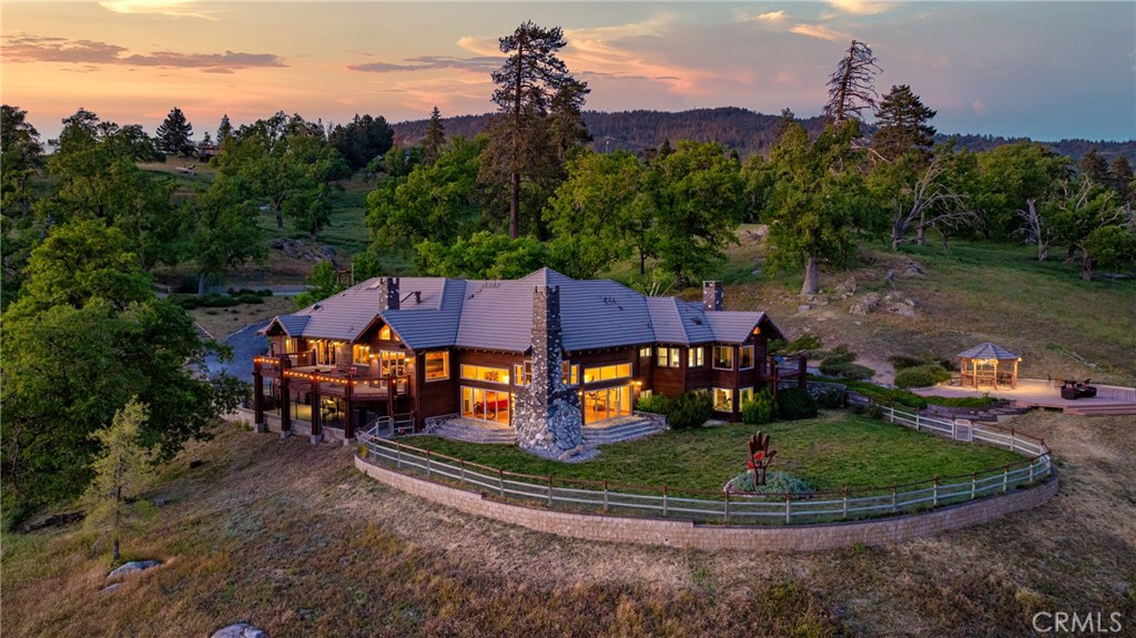 a aerial view of a house with a yard table and chairs