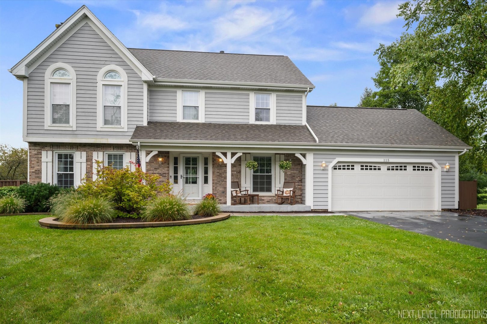 a front view of a house with a garden and yard