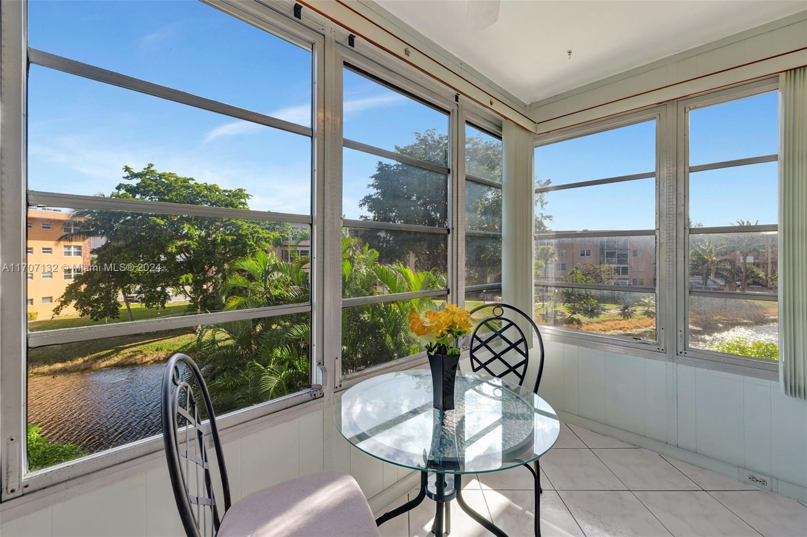 a view of a living room and floor to ceiling window or wooden floor