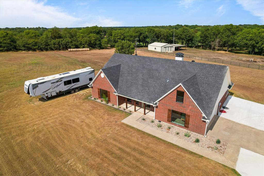 an aerial view of a house with a lake view