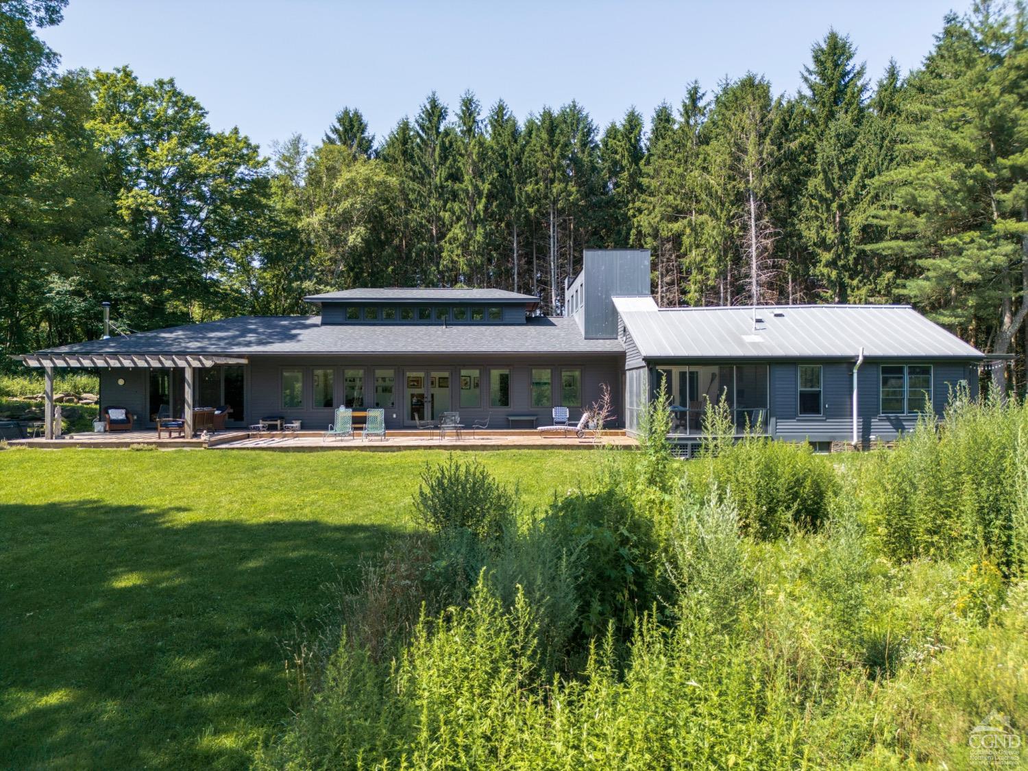 a front view of a house with a garden