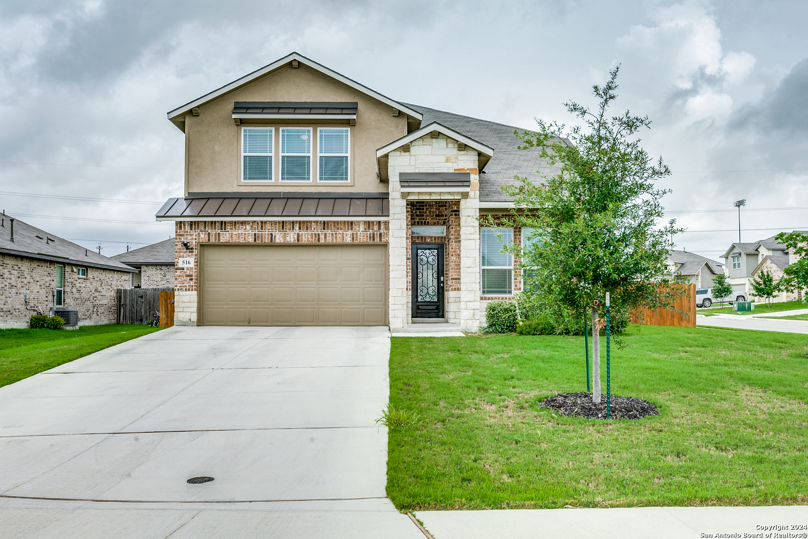 a front view of a house with a yard and garage