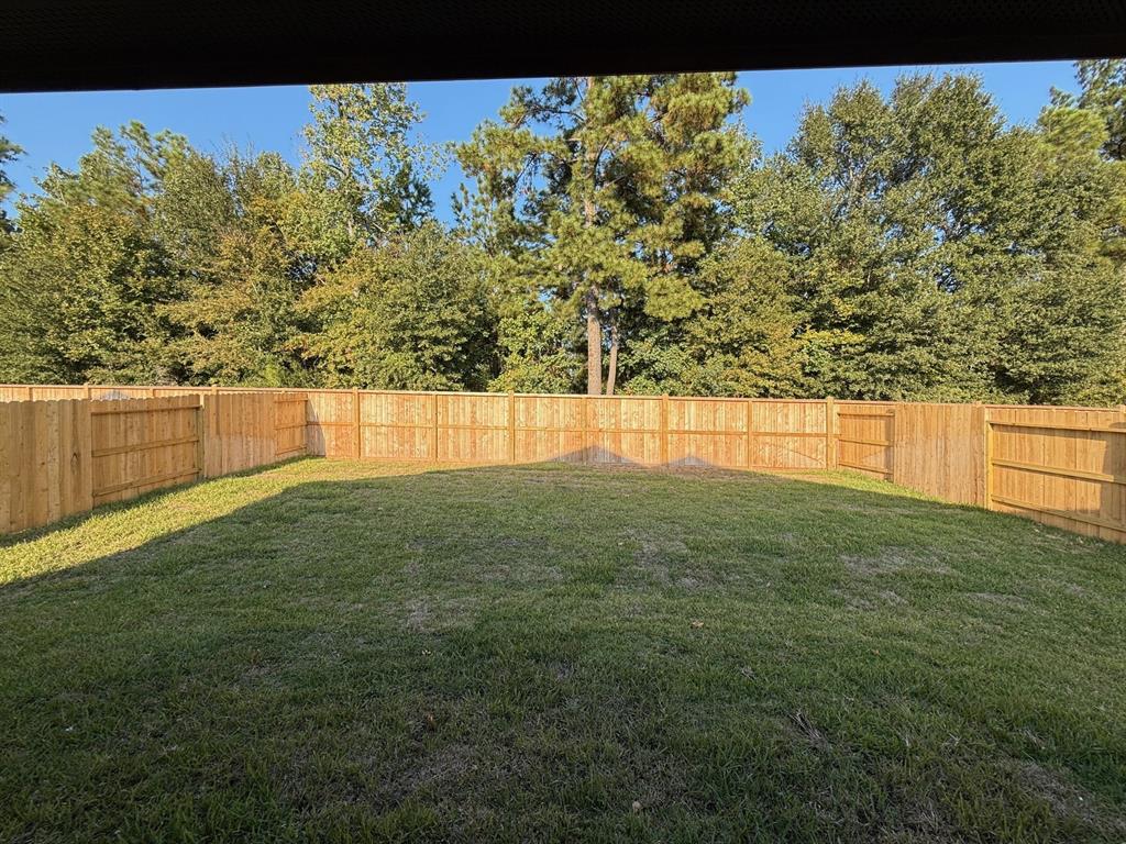 a view of yard with swimming pool and trees