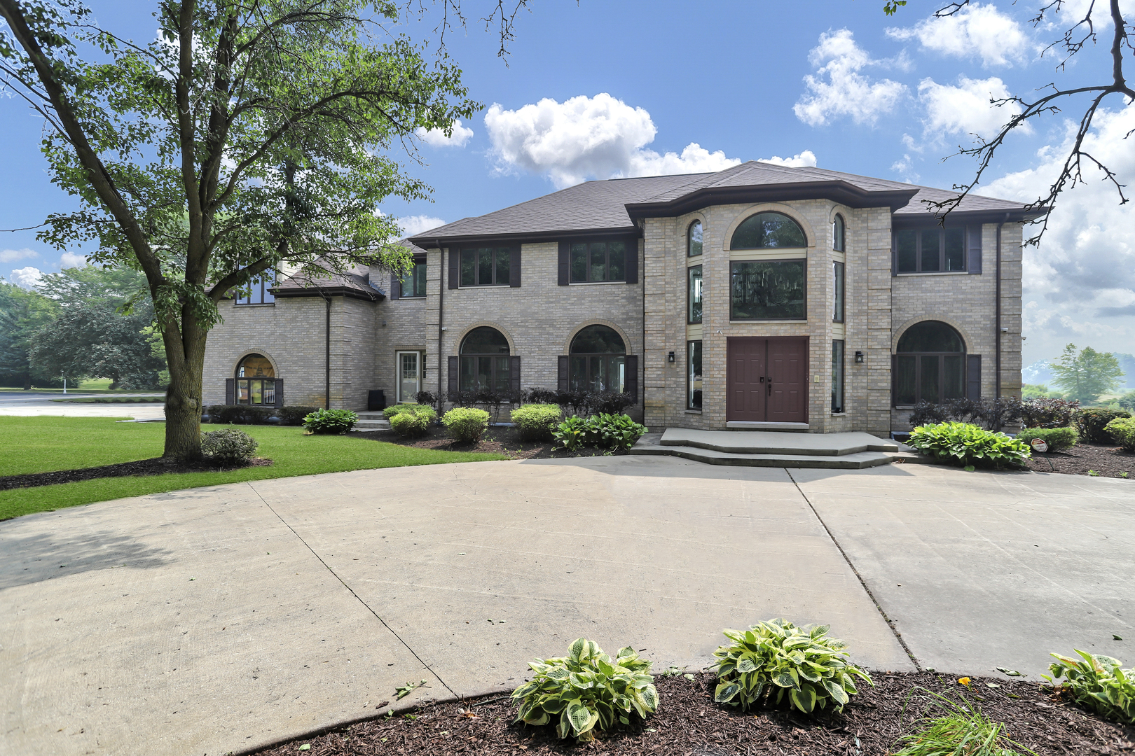 a front view of a house with a garden