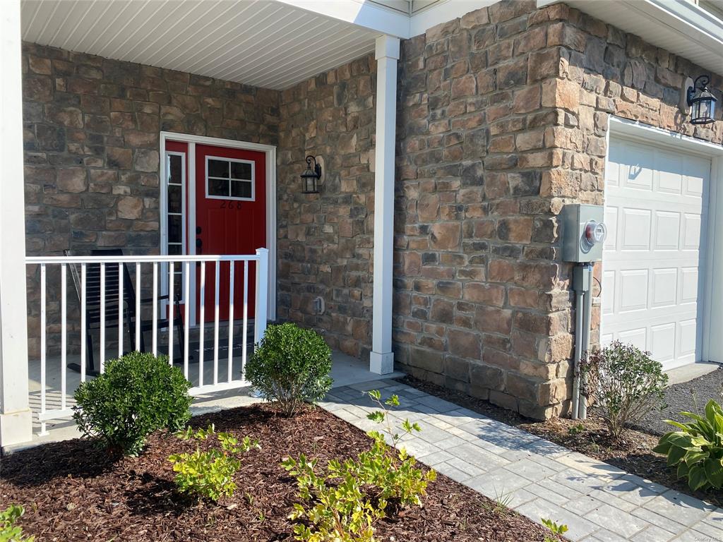 View of exterior entry with a garage