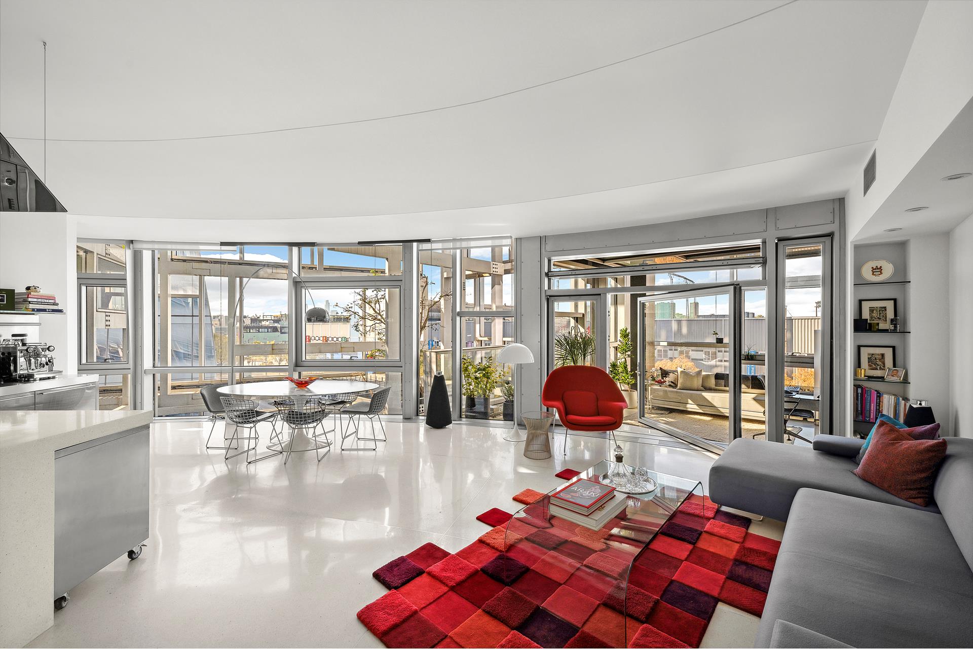 a living room with furniture and large windows