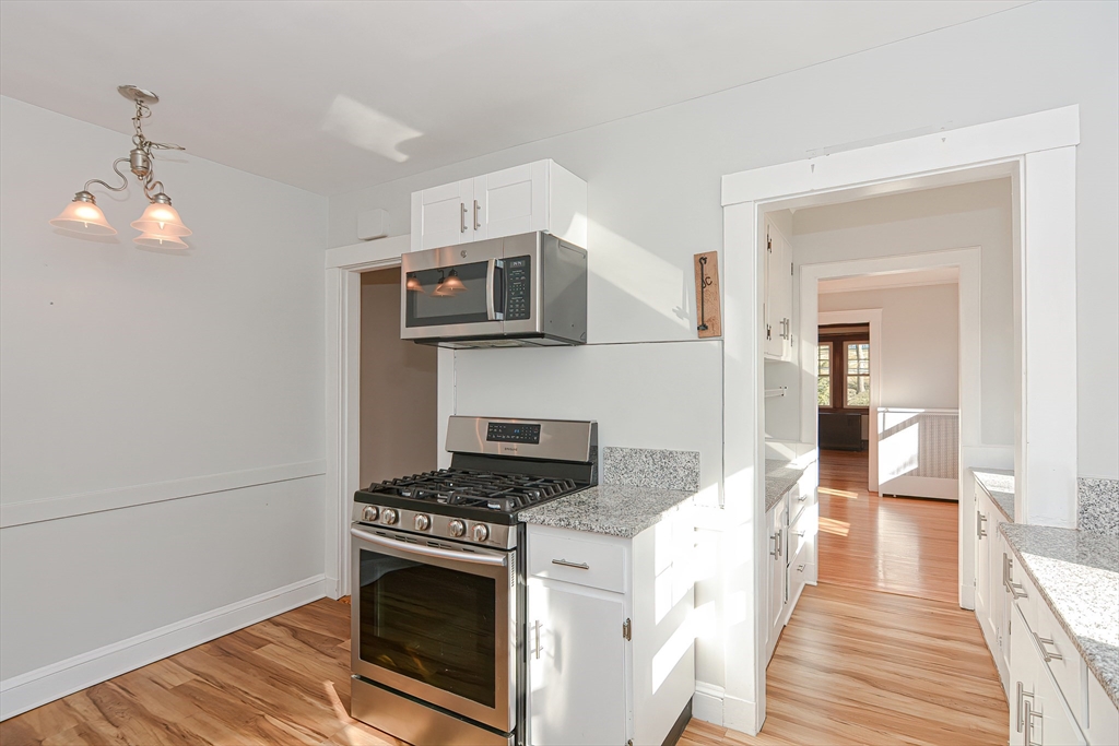 a kitchen with stainless steel appliances granite countertop a stove and a refrigerator