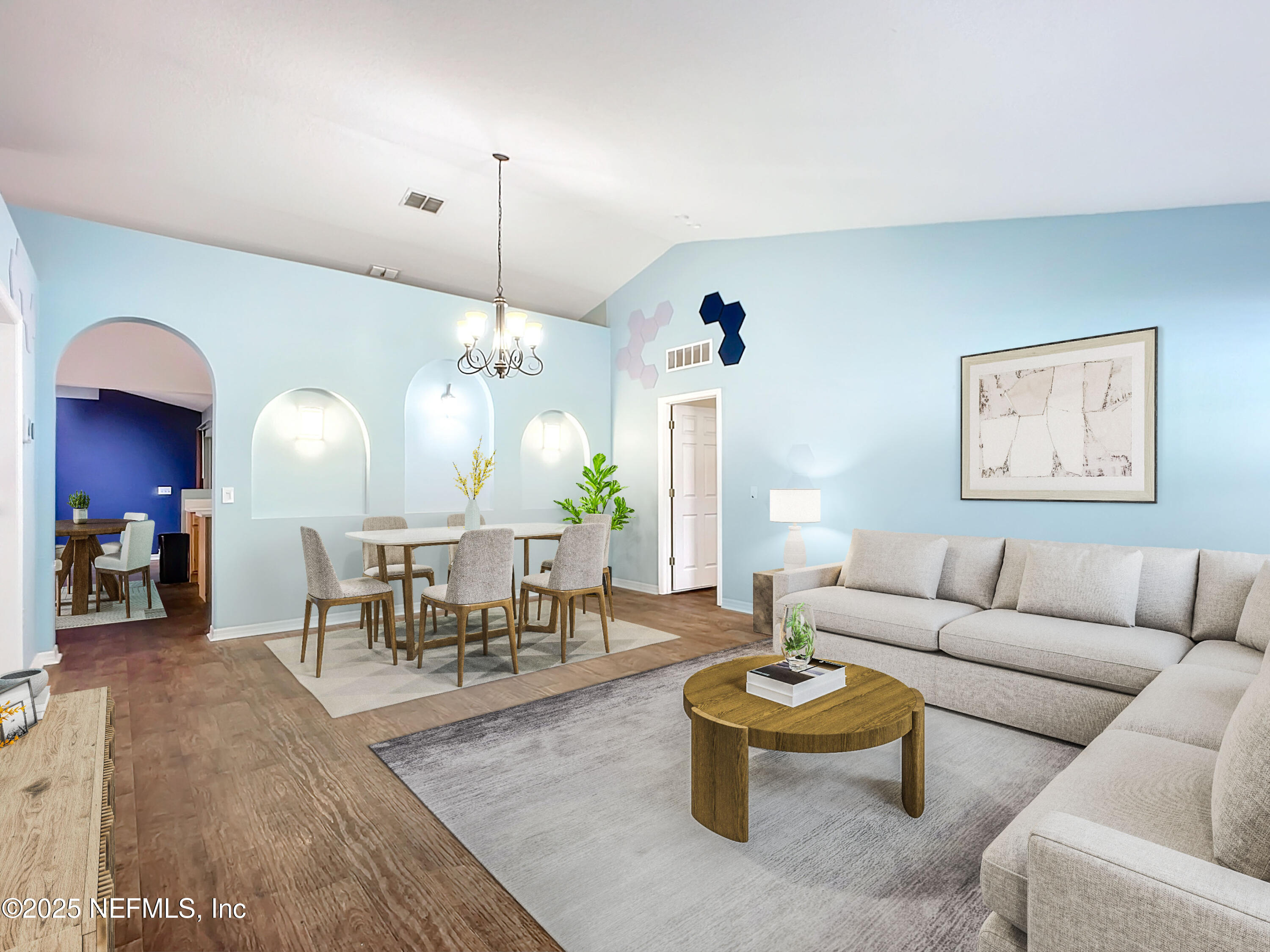 a living room with furniture and a chandelier