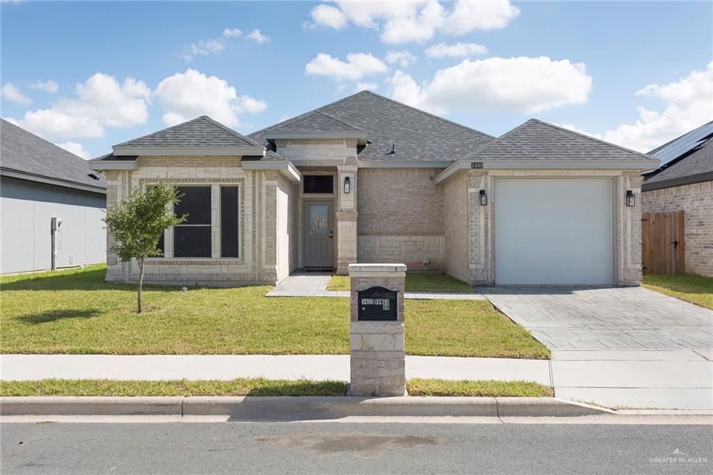 View of front facade with a front yard and a garage