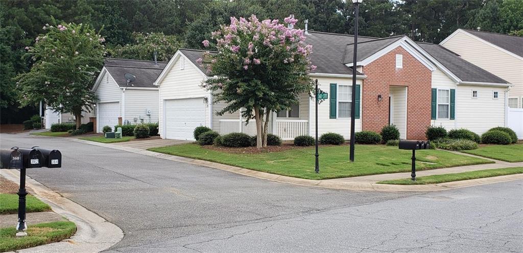 a front view of house with yard and green space