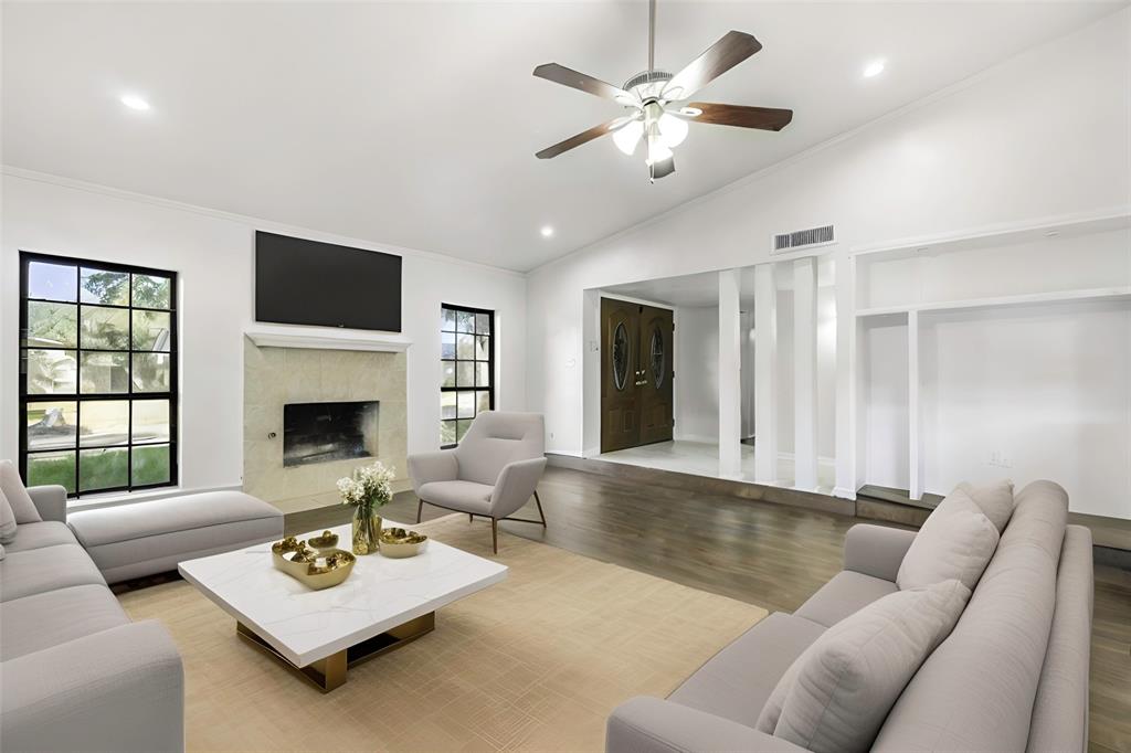 a living room with furniture ceiling fan and a window