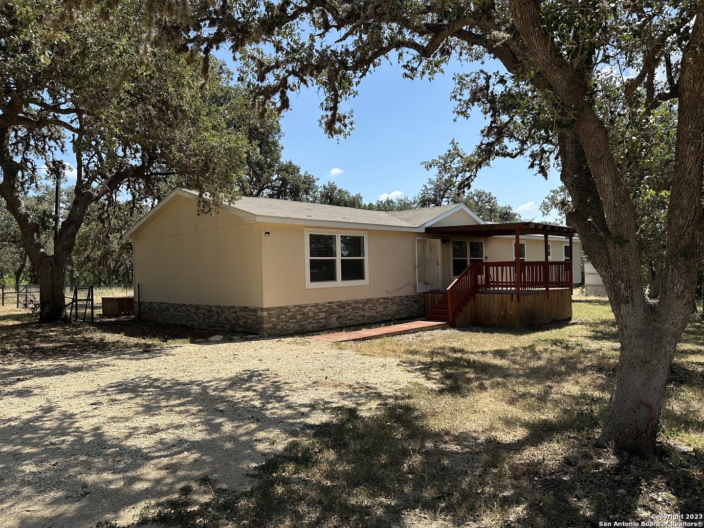 a house that has a tree in front of it