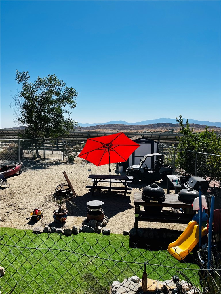 an outdoor space with furniture and umbrella