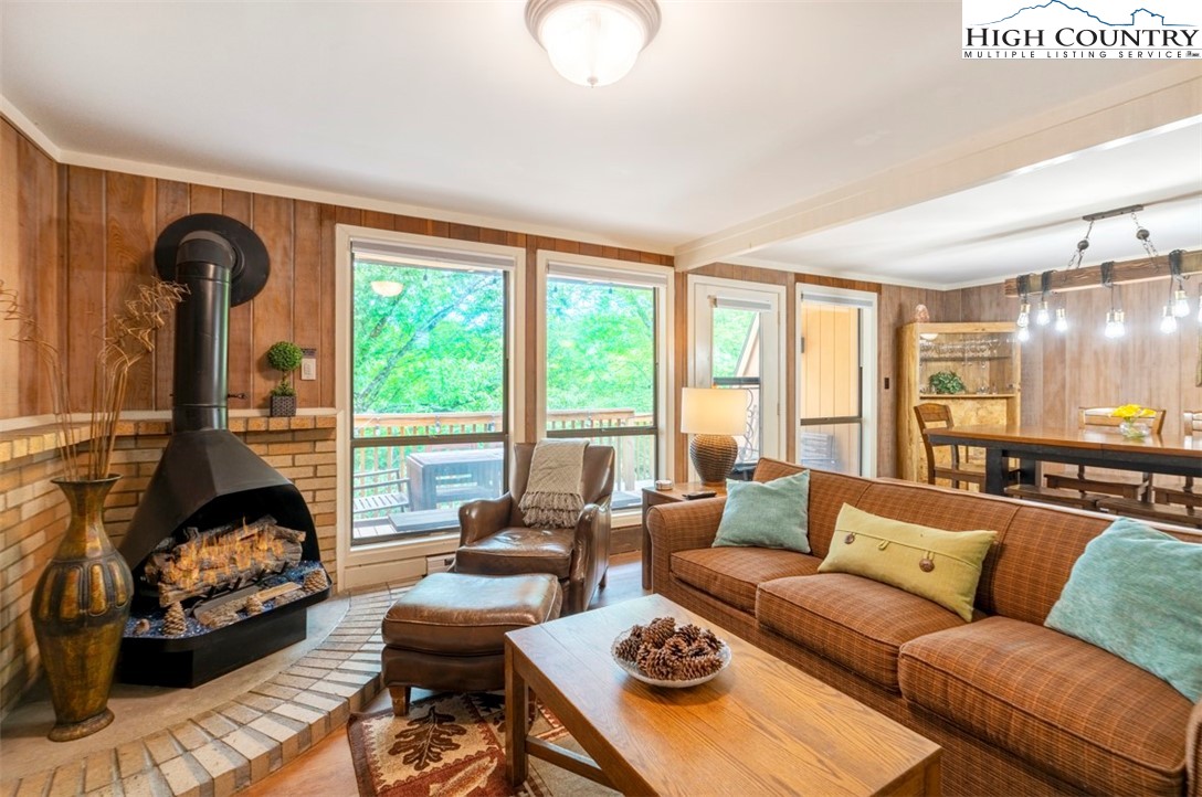 a living room with furniture fireplace and a large window