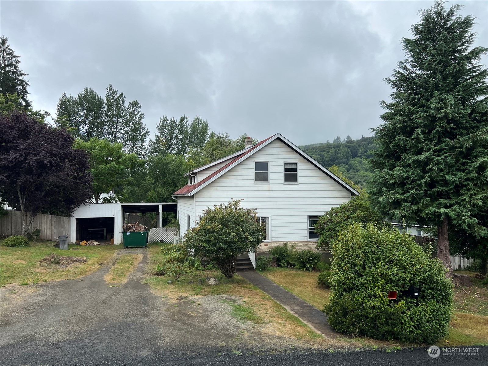 a view of a house with backyard and trees