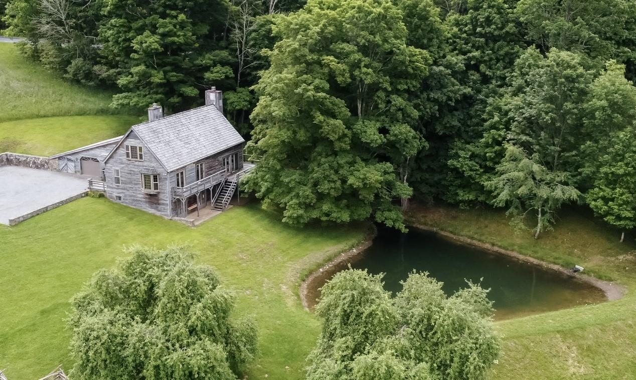 an aerial view of a house with swimming pool and garden