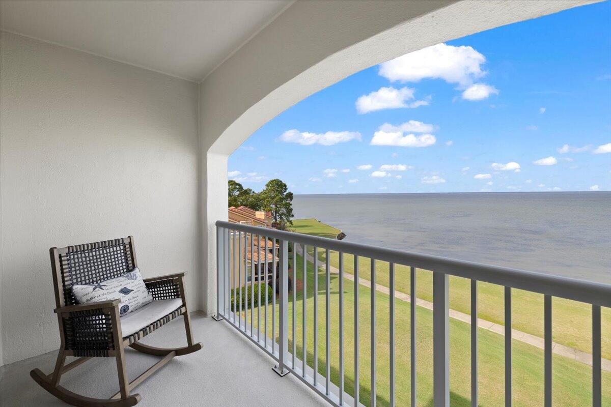 a view of a balcony with chair and table