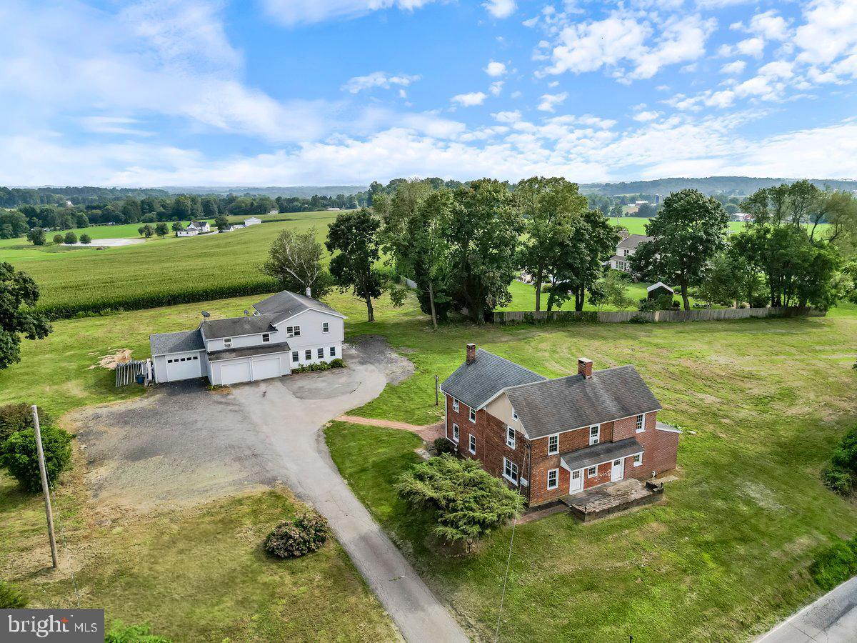 an aerial view of a house with garden space and street view