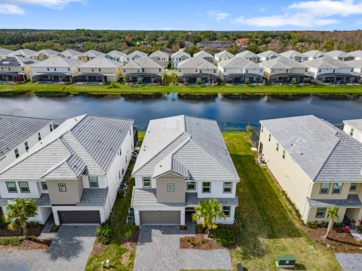 an aerial view of a house with a lake view