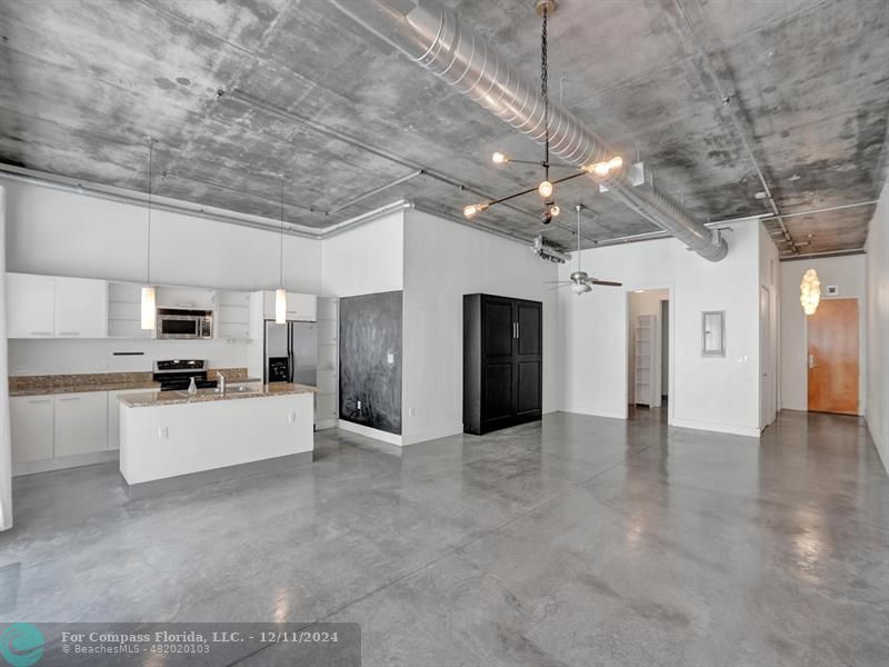 a large kitchen with cabinets and stainless steel appliances