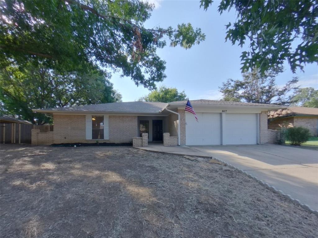 a view of a house with a yard and garage