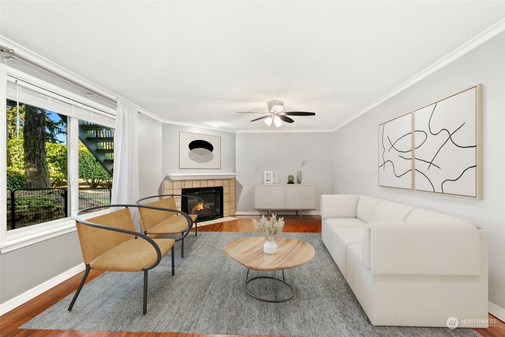 a living room with furniture a fireplace and a large window