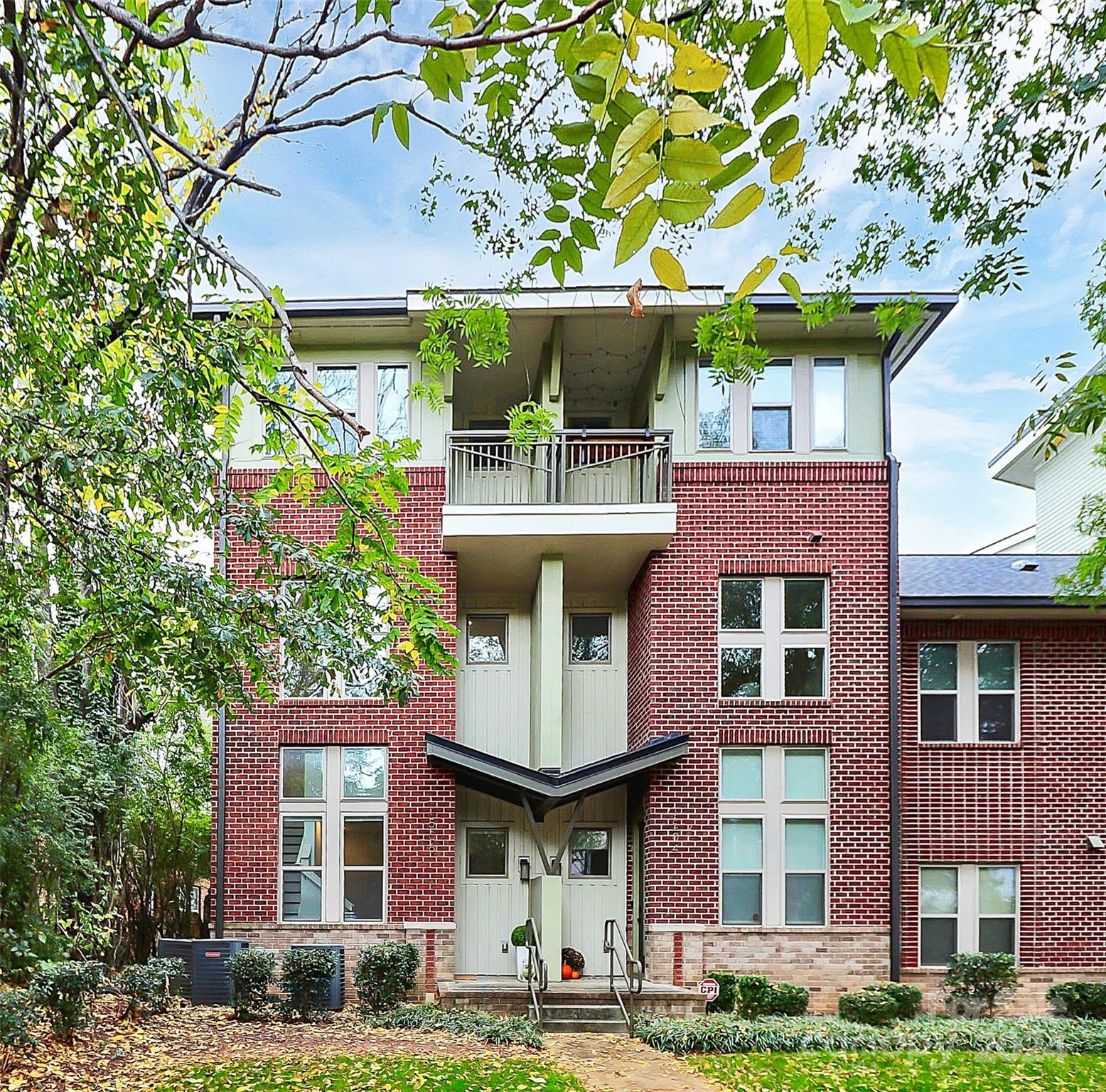 a front view of a building with a garden