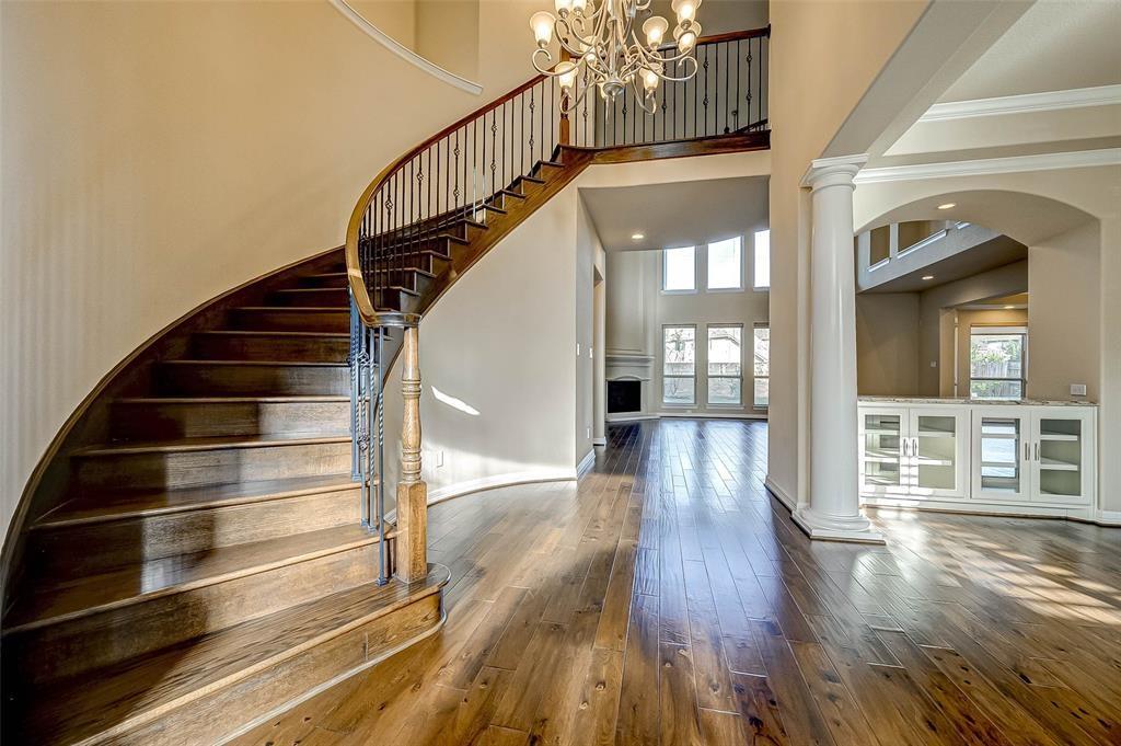 a view of staircase with white walls and wooden floor