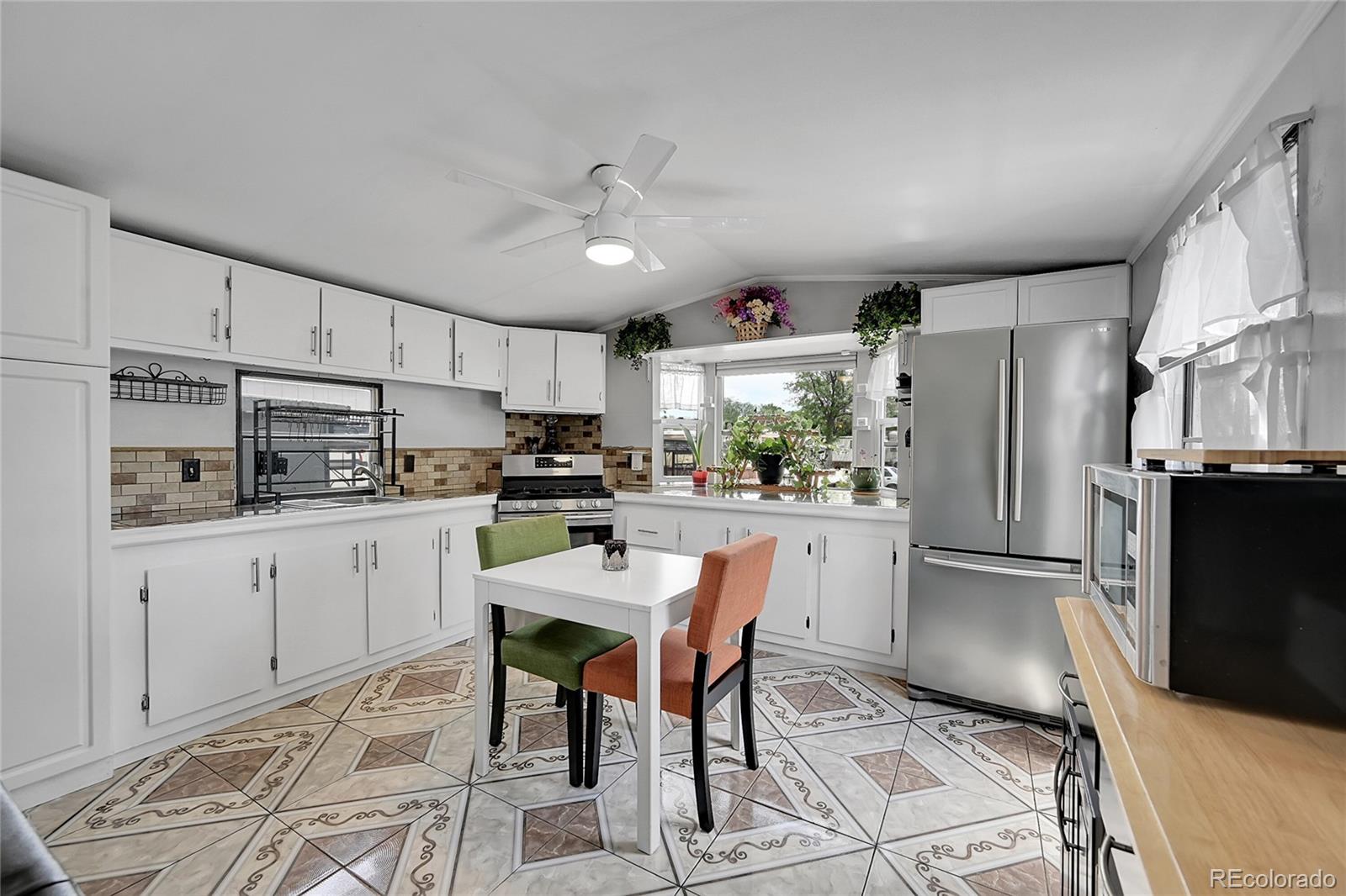 a kitchen with stainless steel appliances a refrigerator sink and cabinets