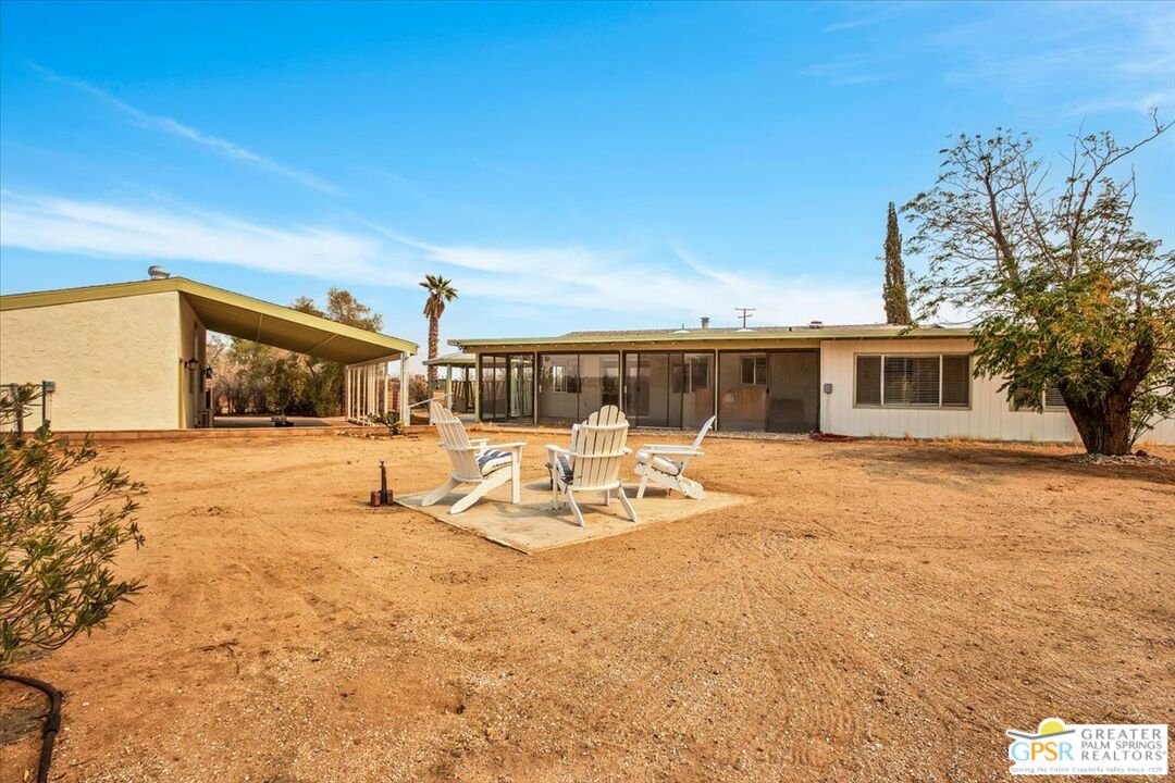 a view of a house with swimming pool and sitting area